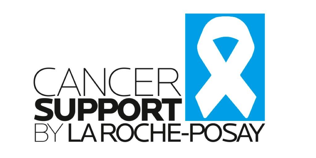 Logo von „Cancer Support by La Roche-Posay“ mit weißer Schleife auf blauem Hintergrund, das Engagement für Krebserkrankte symbolisiert.